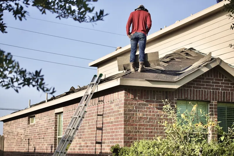 Professional roofer working on a residential roof in Preston North